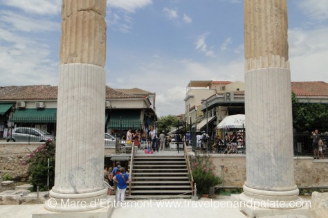 Ruins of the ancient Roman Agora looking out onto markets in modern Athens